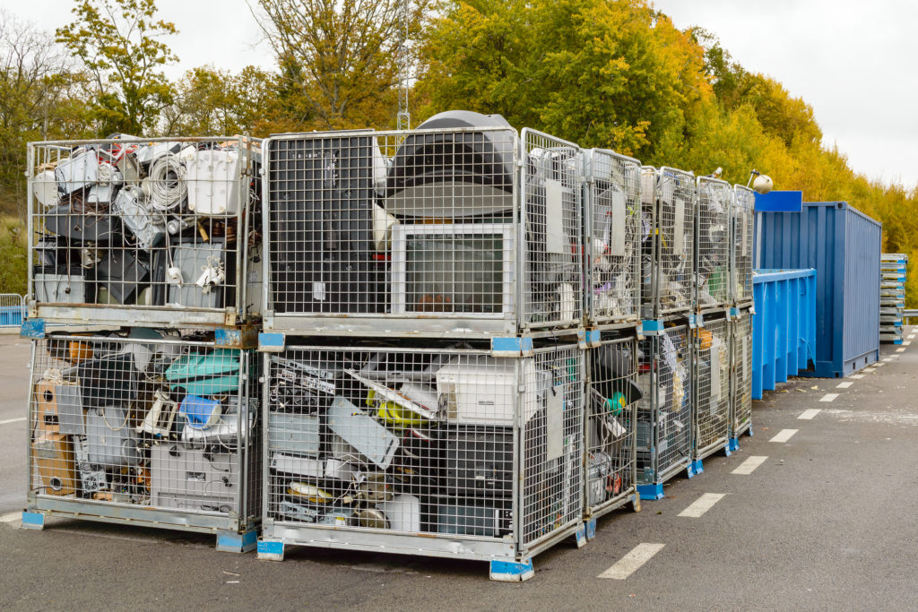 Crates of discarded electronic waste awaiting further processing