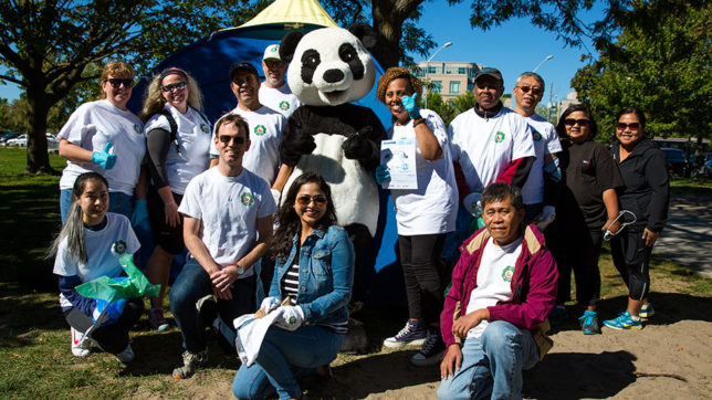 Group of employees posing with panda mascot